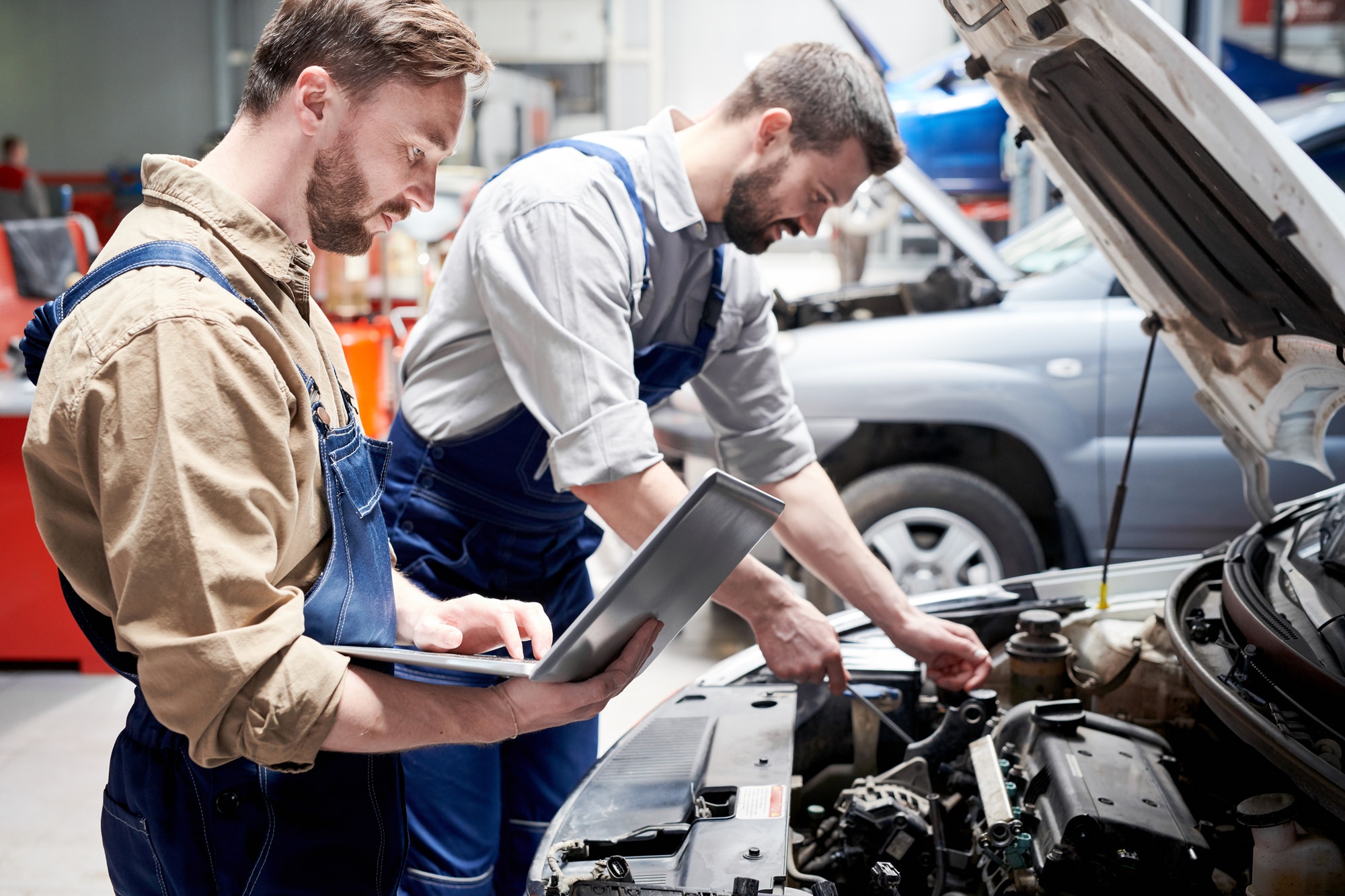 Mechanics Working in Car Service